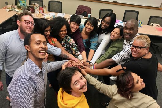 CJ staff and facilitators celebrate a successful meeting. Teddy McGlynn-Wright says that the role of a facilitator is to model the belief that everyone has worth and value: "Part of what we’re doing is making that political stance a reality through our interpersonal actions."